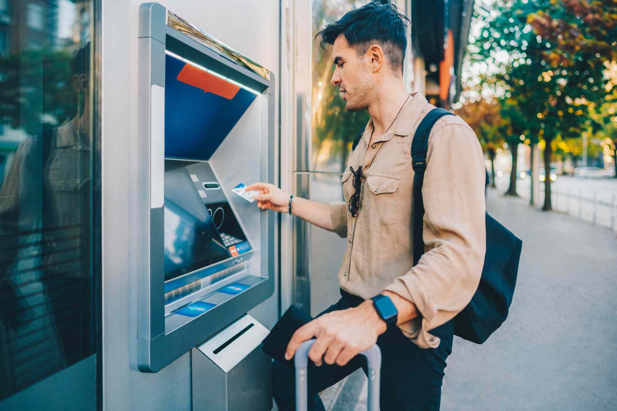 A man uses an ATM.