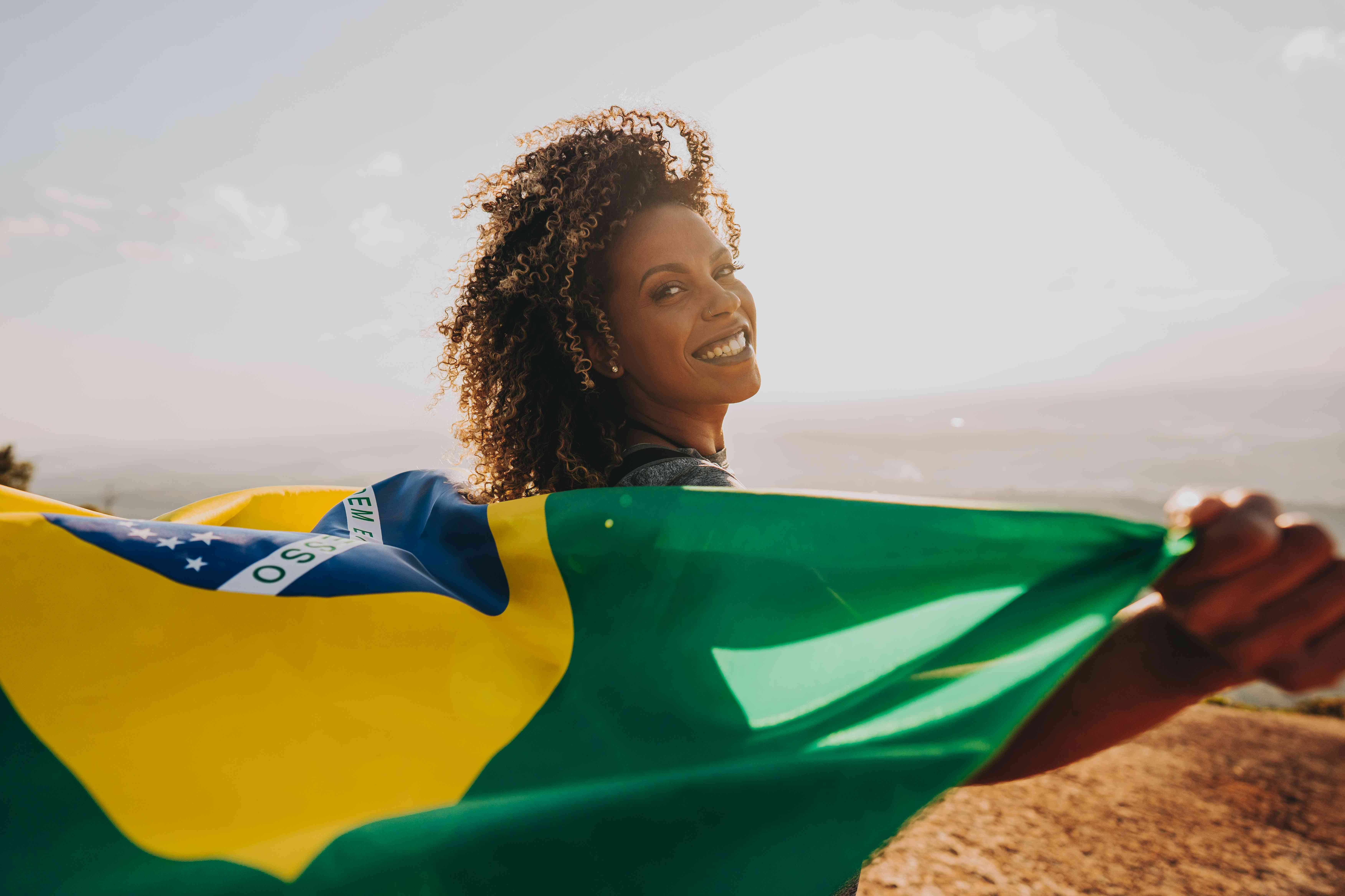 Woman holding a Brazil flag