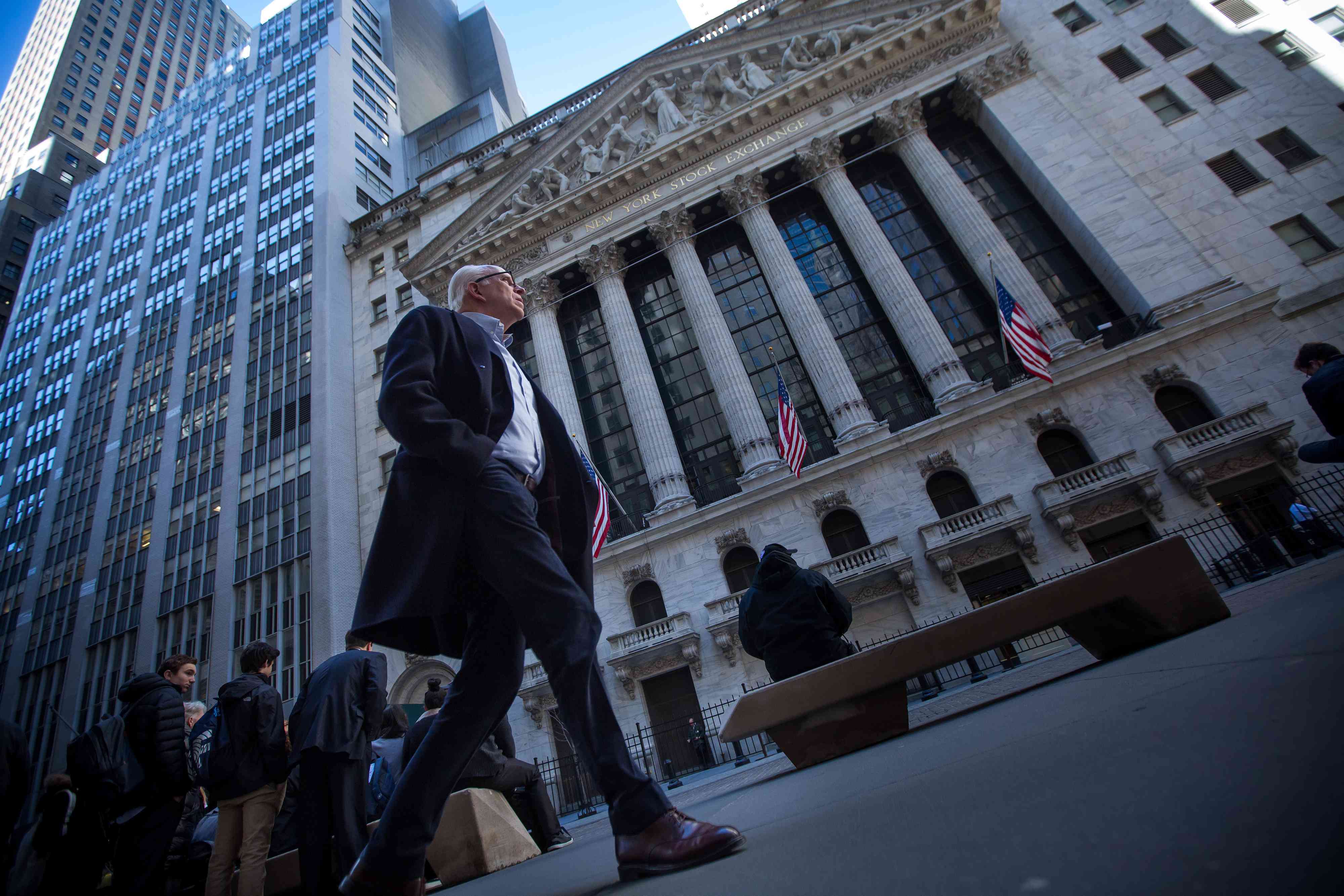 A man walks past the New York Stock Exchange building in New York City